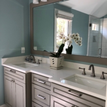 Warm gray vanity and white countertops