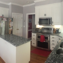 After - white painted cabinets and new hardwood floors