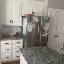 white cabinets with black and white granite