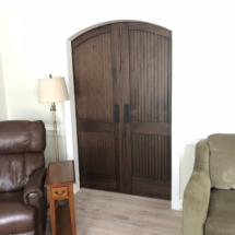 Closed barn doors appear to have arched tops when seen from living room