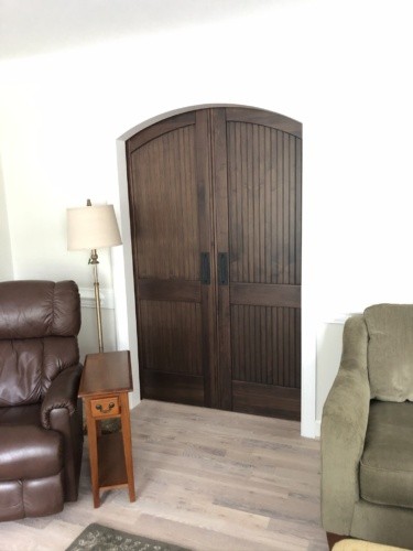 Closed barn doors appear to have arched tops when seen from living room