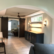 Wine room with custom-built walnut barn doors