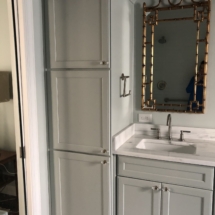 tall linen cabinet and gold mirror