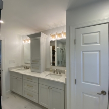 Pale gray double vanity with marble-look 12x24 porcelain floor tile