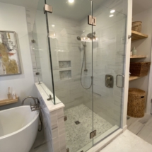 White shower with marble floor and accents