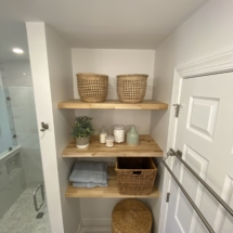 Floating butcher block shelves in storage alcove