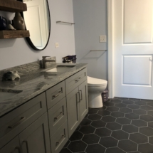Gray vanity with charcoal hex floor