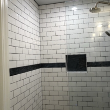 Black accent tile in shower for classic black &amp; white color palette