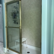 BEFORE - the shower is large but dark and closed off with two walls and a fiberglass shower pan